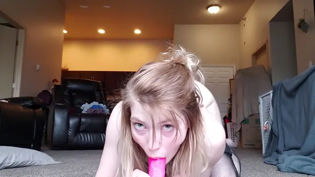 Poster: Teen rides dildo in front of balcony door