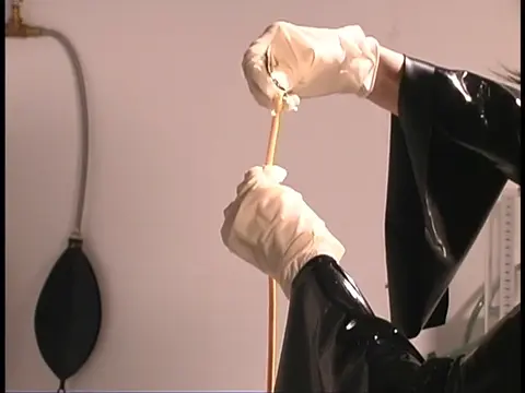 Poster: Latex clad babe doing bondage with friend