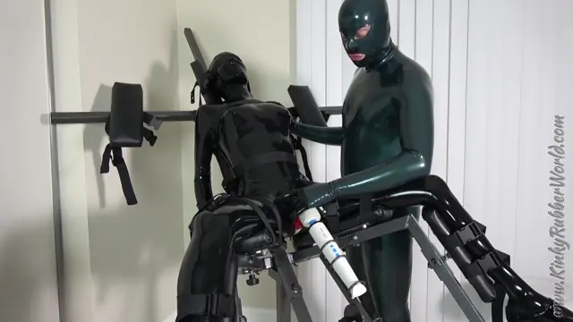 Poster: Kinkyrubberworld Rubberjeff: Intense Orgasm Training strapped to the Lucifer Chair P2 BDSM